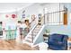 View of the living room staircase, adjacent to the updated kitchen with breakfast bar seating at 12175 Birch St, Thornton, CO 80241