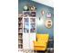 Stylish living room decor with custom shelving, statement chair, and unique wall art at 12175 Birch St, Thornton, CO 80241