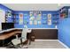 This creative office features a dark wood desk, an ergonomic chair, and blue-painted walls with an array of memorabilia at 12175 Birch St, Thornton, CO 80241
