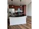 Modern kitchen with stainless steel appliances, dark wood cabinets and sleek black countertops at 891 14Th Street # 1712, Denver, CO 80202