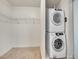 Convenient laundry closet with a stacked washer and dryer unit and wire shelving at 891 14Th Street # 1712, Denver, CO 80202