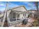Backyard view of the home featuring a gray deck, access to the yard, paver patio with a covered area for entertaining at 13649 Plaster Cir, Broomfield, CO 80023