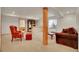 Finished basement with carpet, wooden support beam, bar area, and large bedroom in the background at 13649 Plaster Cir, Broomfield, CO 80023