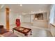 Finished basement with bar area, carpet, a comfortable sofa, ottoman and accent chair at 13649 Plaster Cir, Broomfield, CO 80023