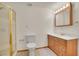 Bathroom featuring a shower with gold trim, a vanity, a mirror, and a toilet at 13649 Plaster Cir, Broomfield, CO 80023
