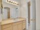 Neutral-toned bathroom featuring a vanity with a single sink, a large mirror, and bright overhead lighting at 13649 Plaster Cir, Broomfield, CO 80023