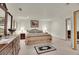 Carpeted bedroom with a dresser, two nightstands, a bed and artwork on the walls at 13649 Plaster Cir, Broomfield, CO 80023