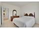 Bright bedroom featuring a traditional style wooden bed frame, dresser, and closet access at 13649 Plaster Cir, Broomfield, CO 80023