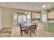 Dining room with chandelier, bay window, table with seating, and view of the kitchen area at 13649 Plaster Cir, Broomfield, CO 80023