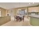 Bright dining room featuring a bay window, chandelier, and table for six near the kitchen at 13649 Plaster Cir, Broomfield, CO 80023