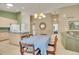 Open concept dining room with chandelier, table, and view of the kitchen and living area at 13649 Plaster Cir, Broomfield, CO 80023
