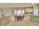 Bright dining room featuring a bay window, chandelier, and table for six near the kitchen at 13649 Plaster Cir, Broomfield, CO 80023