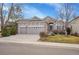 Charming gray home with a well-manicured lawn and a three-car garage at 13649 Plaster Cir, Broomfield, CO 80023