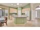 Bright kitchen with an island, breakfast table, and lots of natural light at 13649 Plaster Cir, Broomfield, CO 80023
