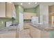 Kitchen with light wood cabinets, stone countertops, and stainless appliances at 13649 Plaster Cir, Broomfield, CO 80023