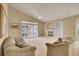 Bright living room with high ceilings, fireplace, and large windows for natural light at 13649 Plaster Cir, Broomfield, CO 80023