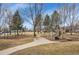 Community playground with swings, slides, and a seating area at 13649 Plaster Cir, Broomfield, CO 80023