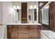 Modern bathroom featuring a double vanity, large mirrors, and a shower at 1000 E 1St Ave # 405, Denver, CO 80218