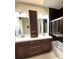 Modern bathroom featuring a double vanity, large mirrors, and a shower at 1000 E 1St Ave # 405, Denver, CO 80218