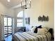 Bedroom boasts abundant light, balcony access, and modern lighting fixture at 1000 E 1St Ave # 405, Denver, CO 80218