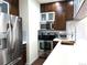 Modern kitchen featuring stainless steel appliances, subway tile backsplash, and white countertops at 1000 E 1St Ave # 405, Denver, CO 80218