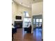 Bright living room with vaulted ceilings, a fireplace, and access to a balcony with a view at 1000 E 1St Ave # 405, Denver, CO 80218