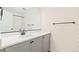 Bright bathroom featuring modern vanity with gray cabinetry and white countertop at 5745 S Buchanan Ct # C, Aurora, CO 80016