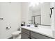 The well-lit bathroom showcases a modern vanity, sleek fixtures, and a glass-enclosed shower with black hardware at 5745 S Buchanan Ct # C, Aurora, CO 80016