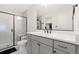 Modern bathroom with a glass-enclosed shower, vanity, and a well-lit mirror at 5745 S Buchanan Ct # C, Aurora, CO 80016