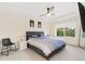 Comfortable bedroom with a gray bed frame, ceiling fan, and a view of the green outdoors at 5745 S Buchanan Ct # C, Aurora, CO 80016