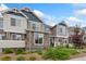 A townhome showing stone and siding accents, updated colors and landscaping including mulch and manicured greenery at 5745 S Buchanan Ct # C, Aurora, CO 80016