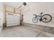 Spacious garage with a bicycle hanging on the wall and overhead door at 5745 S Buchanan Ct # C, Aurora, CO 80016