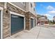 Attached garages feature stone accents and paneled doors, adding to the property's curb appeal at 5745 S Buchanan Ct # C, Aurora, CO 80016