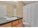 Bathroom featuring a single vanity and tub/shower with white curtain at 8260 E 24Th Dr, Denver, CO 80238
