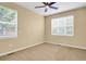 Serene bedroom with plush carpeting, natural light, and a ceiling fan at 8260 E 24Th Dr, Denver, CO 80238