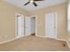 Neutral bedroom with carpet, ceiling fan, and doors to bathroom and closet at 8260 E 24Th Dr, Denver, CO 80238