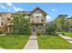 Inviting two-story home with a well-manicured lawn and charming balcony at 8260 E 24Th Dr, Denver, CO 80238