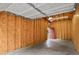 Inside a bare garage with open studs on the side walls and a door to the exterior at 8260 E 24Th Dr, Denver, CO 80238
