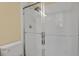 Bathroom shower with glass door and tiled surround at 8260 E 24Th Dr, Denver, CO 80238