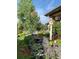 Landscaped backyard with mature trees, rock features, and a birdhouse at 5960 S Watson Ln, Littleton, CO 80123
