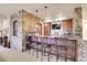 Basement bar with stone accent wall and seating at 5960 S Watson Ln, Littleton, CO 80123