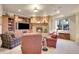 Finished basement recreation area with fireplace and seating at 5960 S Watson Ln, Littleton, CO 80123