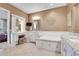 Bathroom with double vanities, a large soaking tub, and a separate shower at 5960 S Watson Ln, Littleton, CO 80123
