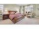 Luxurious main bedroom with a comfortable sleigh bed and sitting area at 5960 S Watson Ln, Littleton, CO 80123