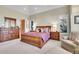 Elegant bedroom with a king-size sleigh bed, and plenty of natural light at 5960 S Watson Ln, Littleton, CO 80123