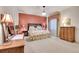 Spacious bedroom with floral bedding and an accent wall at 5960 S Watson Ln, Littleton, CO 80123
