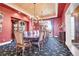 Elegant dining room with chandelier, rich wall color, and ornate furnishings at 5960 S Watson Ln, Littleton, CO 80123