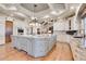 Gourmet kitchen boasts a large island, granite countertops, and custom cabinetry at 5960 S Watson Ln, Littleton, CO 80123