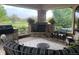 Outdoor patio with fireplace and seating area at 5960 S Watson Ln, Littleton, CO 80123