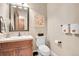 Elegant powder room with wood vanity and decorative mirror at 5960 S Watson Ln, Littleton, CO 80123
